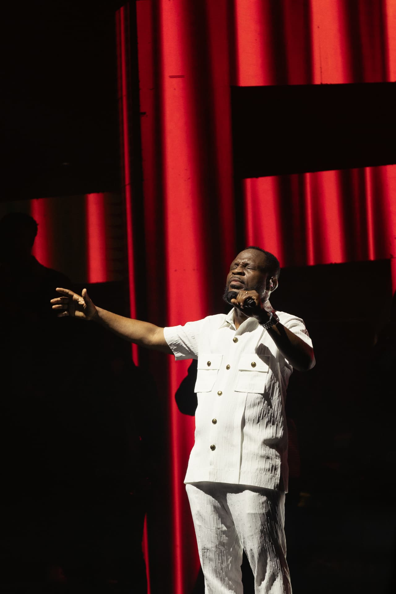 Pastor Edwin Dadson leading a worship gathering on stage